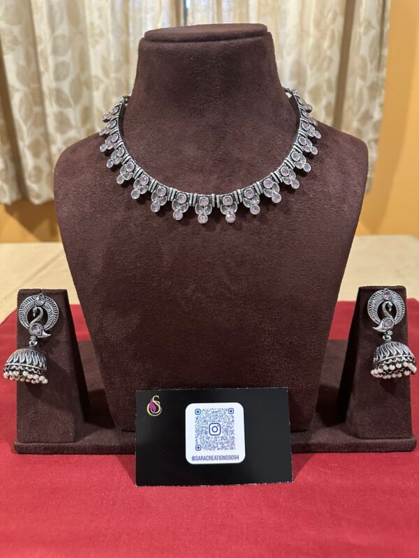 Exquisite Pink Stone Studded Oxidised Jewellery Set with Peacock Jumkha and White Pearls